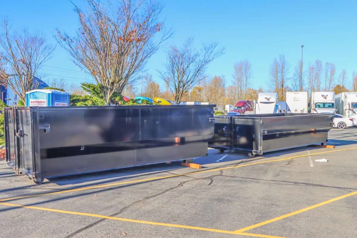 Professional dumpster rental service with roll-off container on residential driveway in Hampton